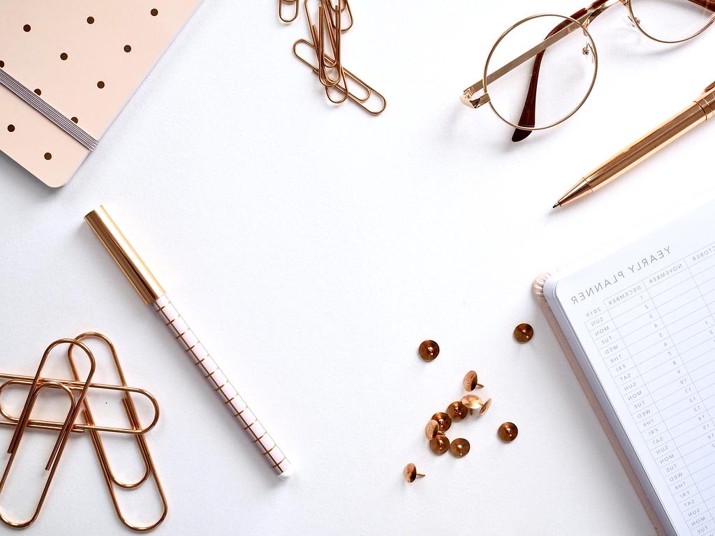Planner and coffee cup on a clean desk
