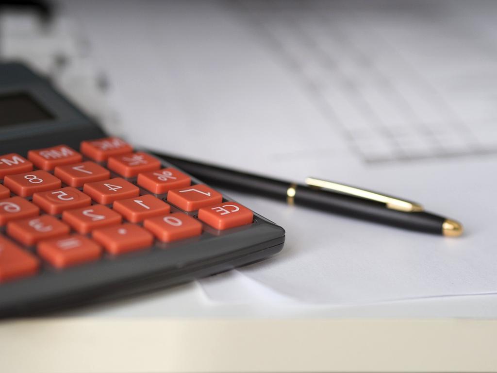 Workspace with a laptop, notebooks and coffee on the desk