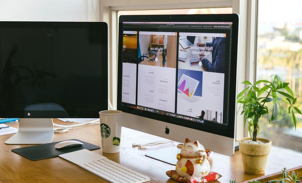 Modern office desk setup with various productivity tools and plants